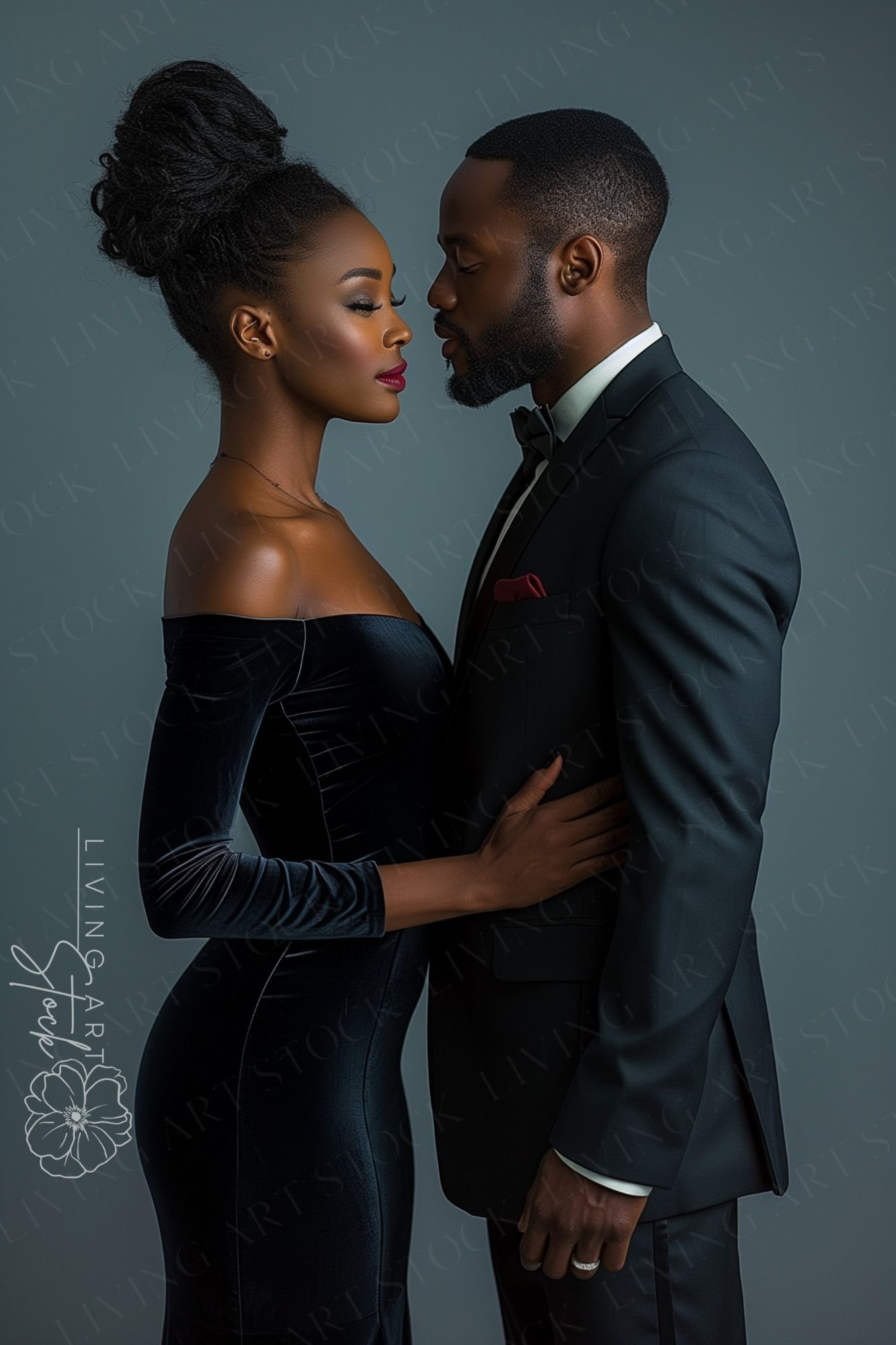 A studio portrait of a refined Black couple standing face-to-face in a state of quiet intimacy. The woman wears a form-fitting, off-the-shoulder velvet gown in deep navy, her hair styled in an intricate high bun. The man is dressed in a classic black tuxe