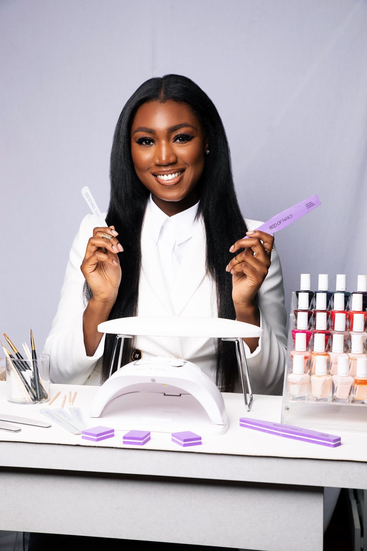 Nail technician efficiently applying gel polish in a modern studio, demonstrating strategies to speed up nail services without compromising quality