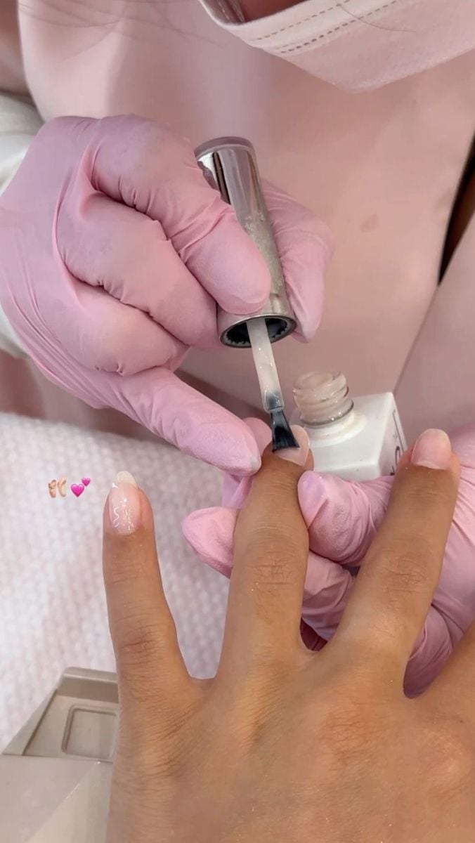 Nail technician professionally consulting a client to manage expectations, illustrating how to handle difficult clients.