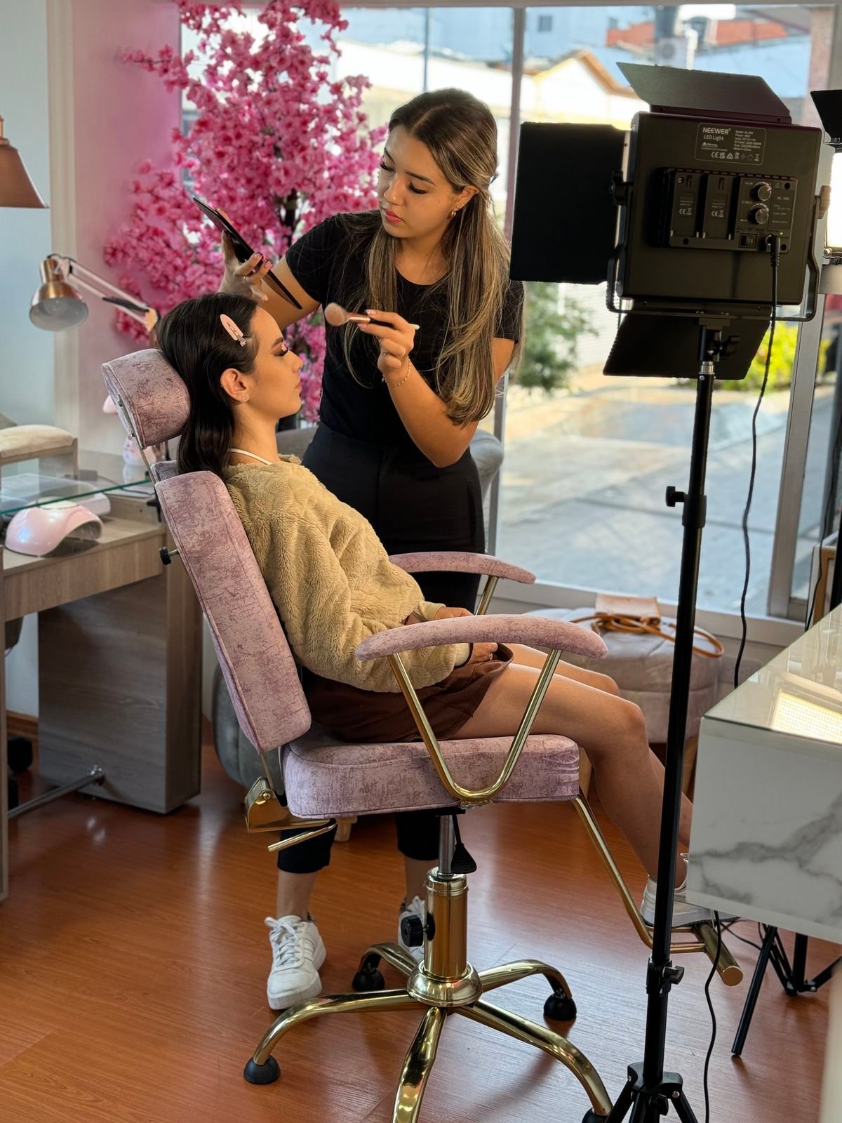 Nail technician photographing nails for social media, demonstrating strategies to grow a nail business online.