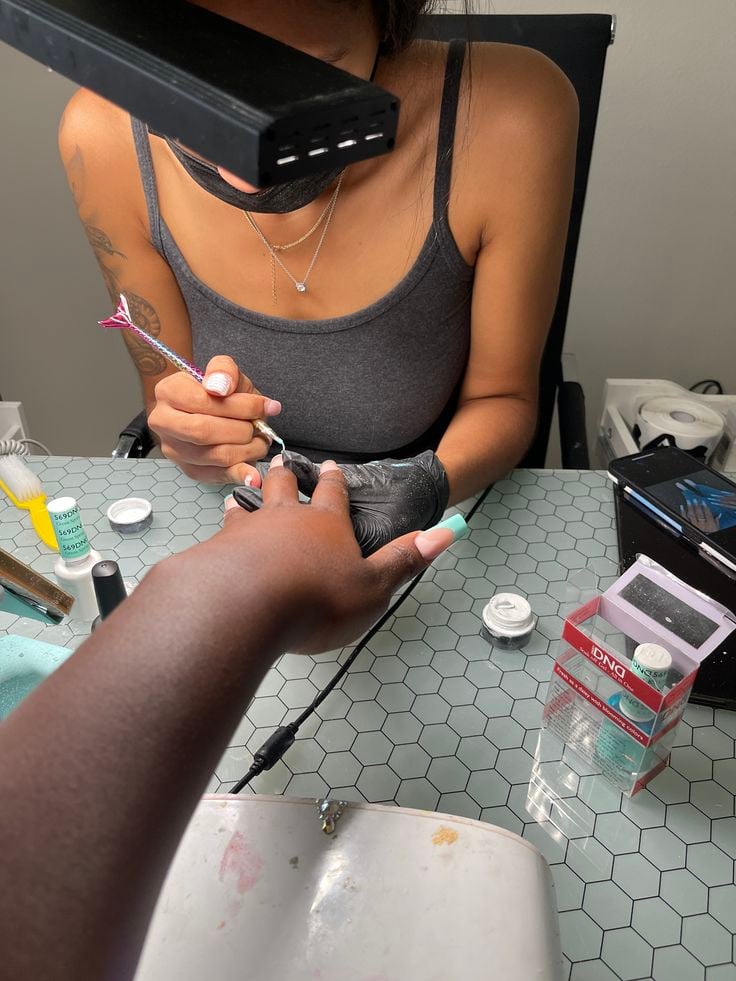 Nail technician addressing a client complaint professionally to maintain satisfaction and grow a nail business.