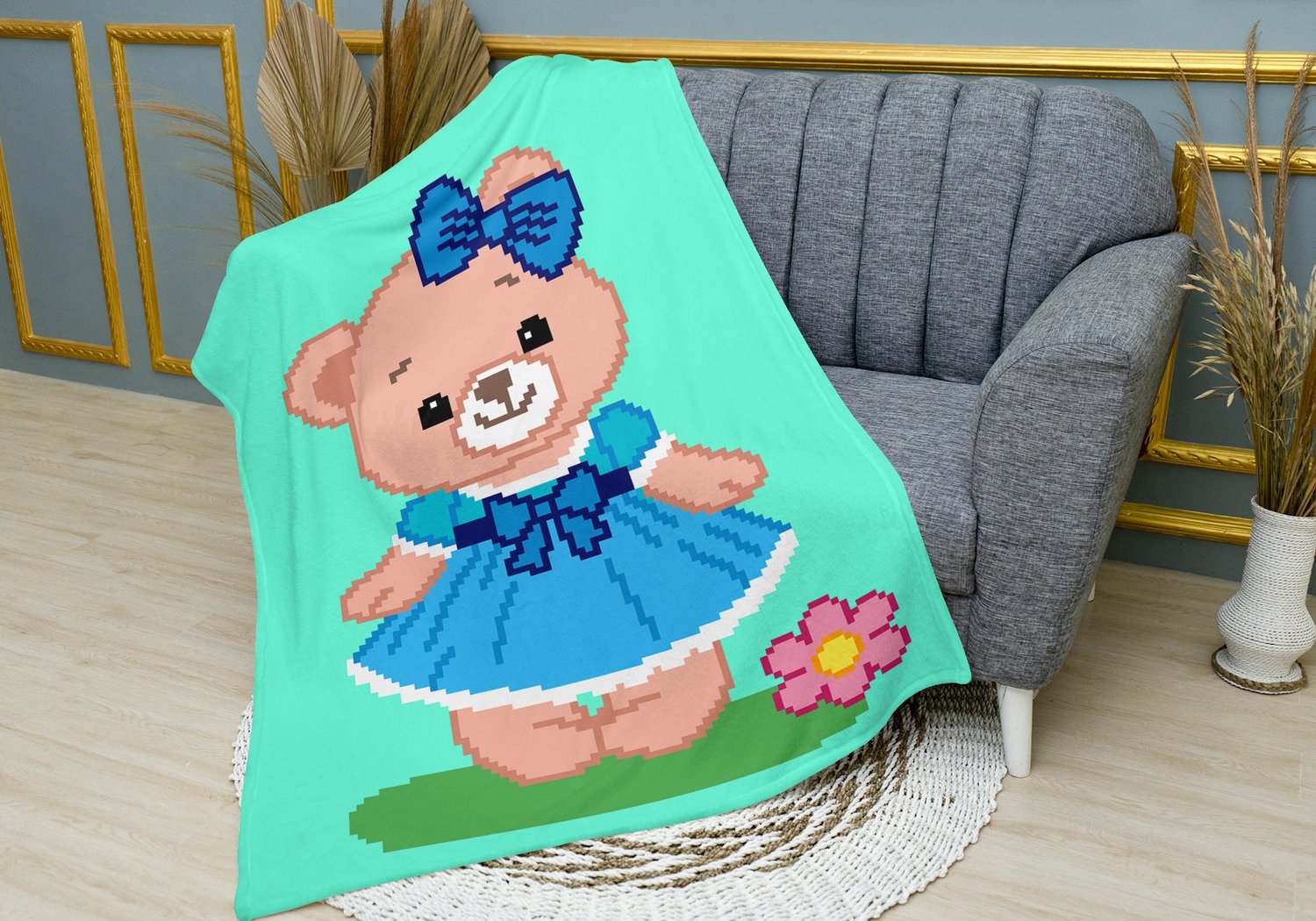 Finished Teddy Girl crochet blanket with teddy bear design displayed over armchair.