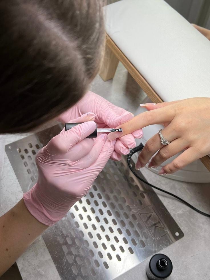 Nail technician creating a relaxing client experience in a serene nail studio to increase retention.