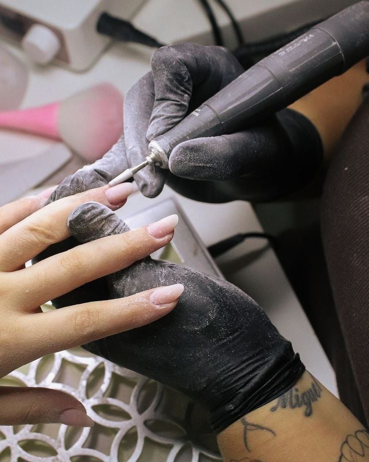 Nail technician marketing their nail business locally to attract new clients and grow the business.