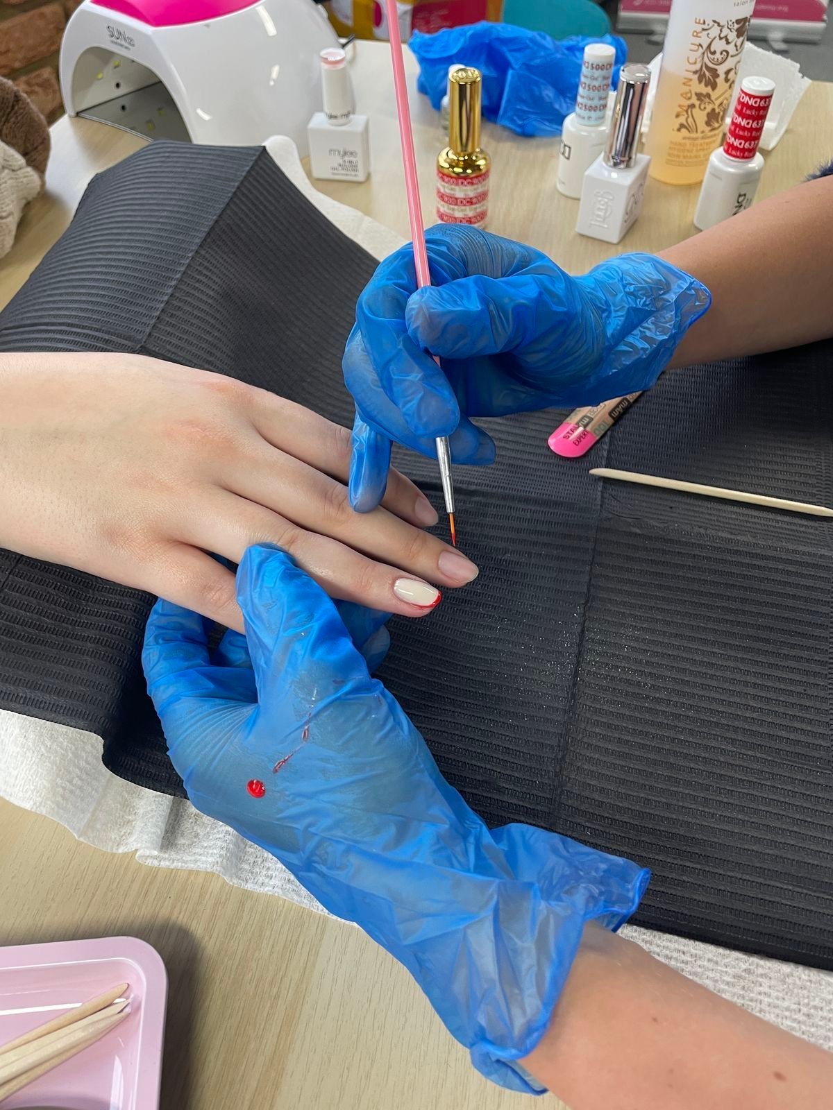Nail technician managing seasonal slow periods to maintain business growth.