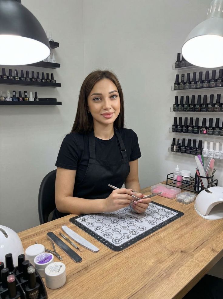 Nail technician calculating service prices to maximize profit and grow the business.