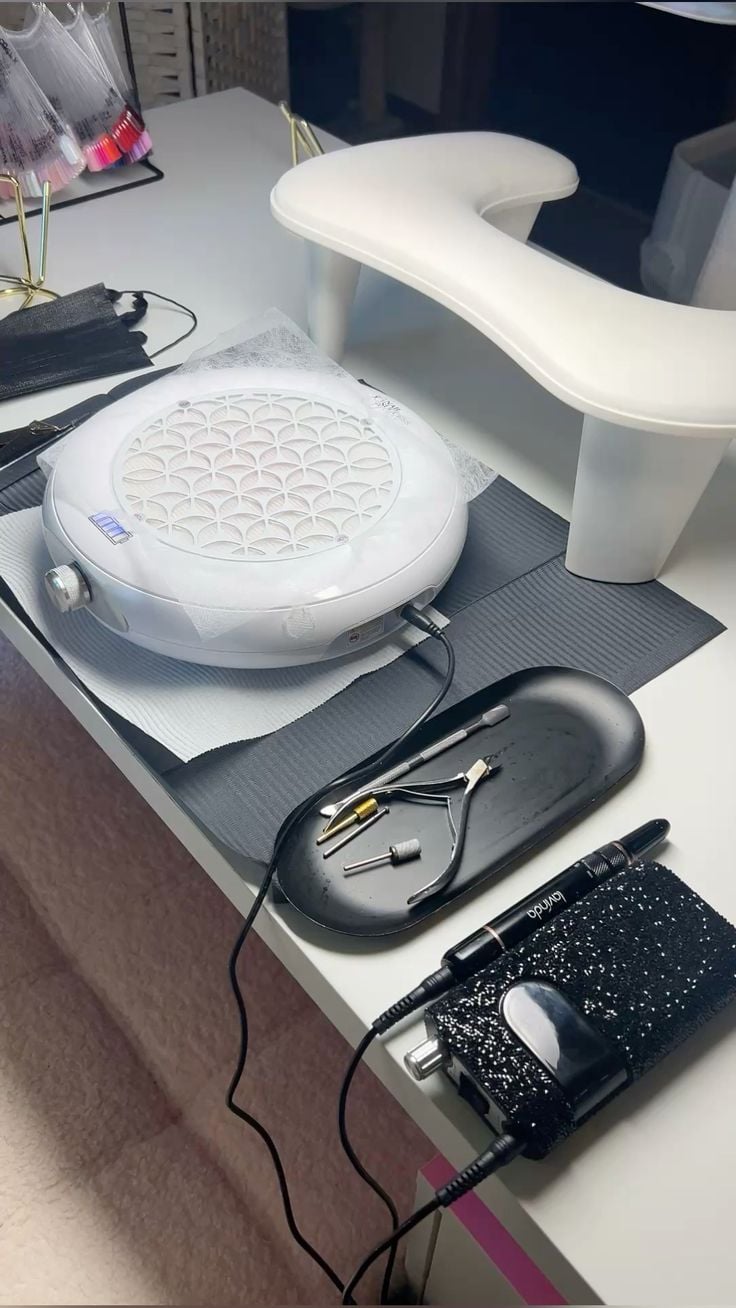 Nail technician creating a relaxing client experience in a calm, professional studio to grow the business.