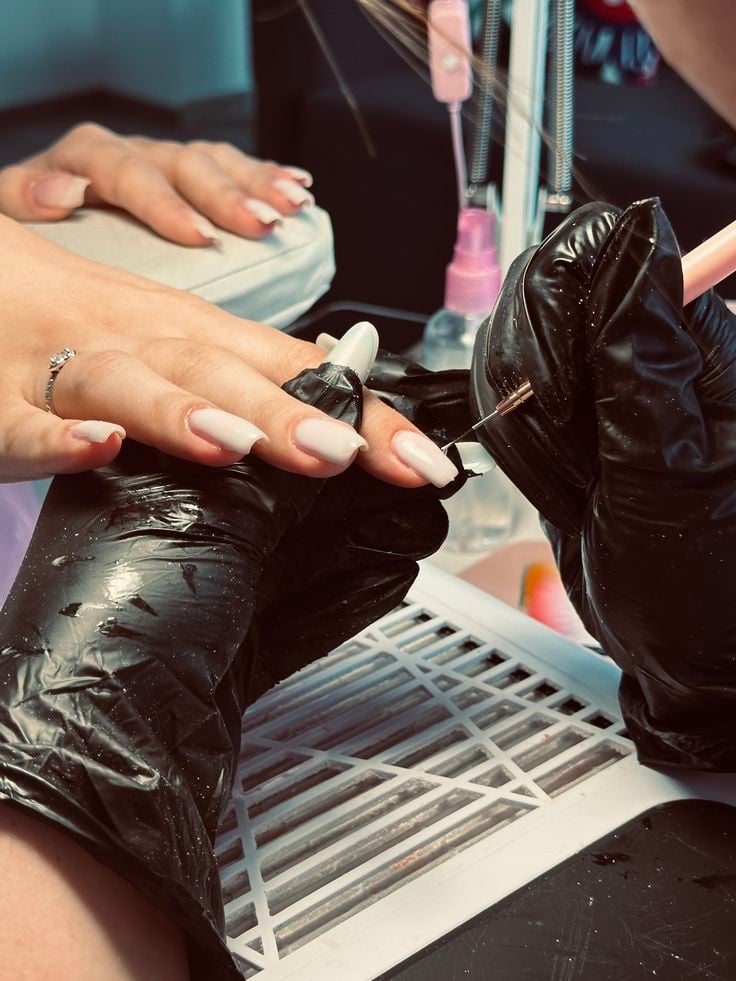 Nail technician using a client follow-up system to increase repeat bookings and grow the business.