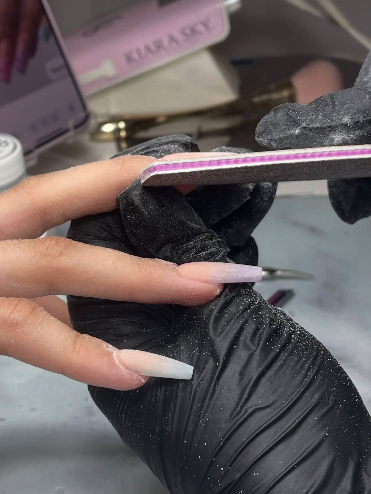 Nail technician using a client follow-up system to increase repeat bookings and grow the business.