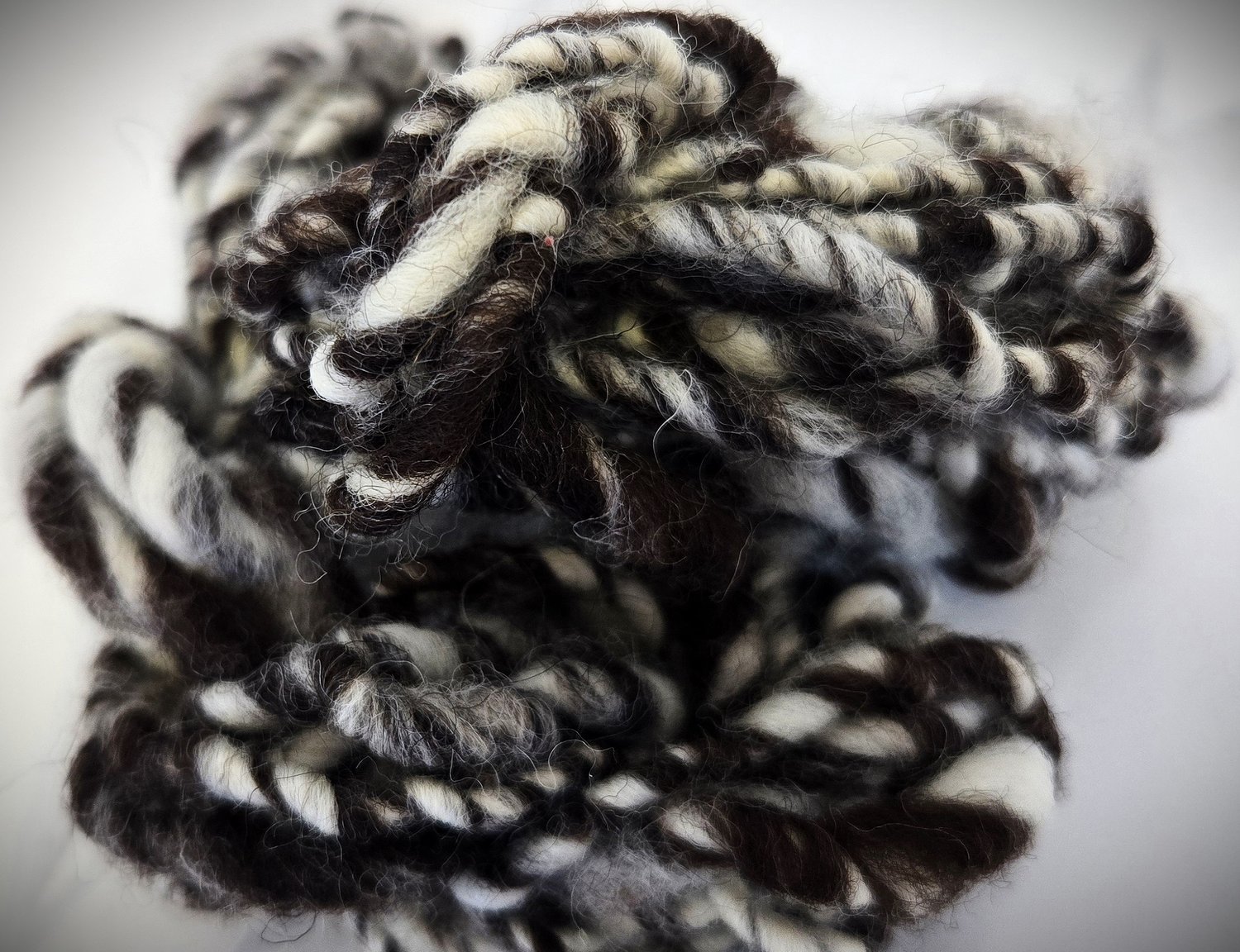vignette image of brown and white wool art yarn