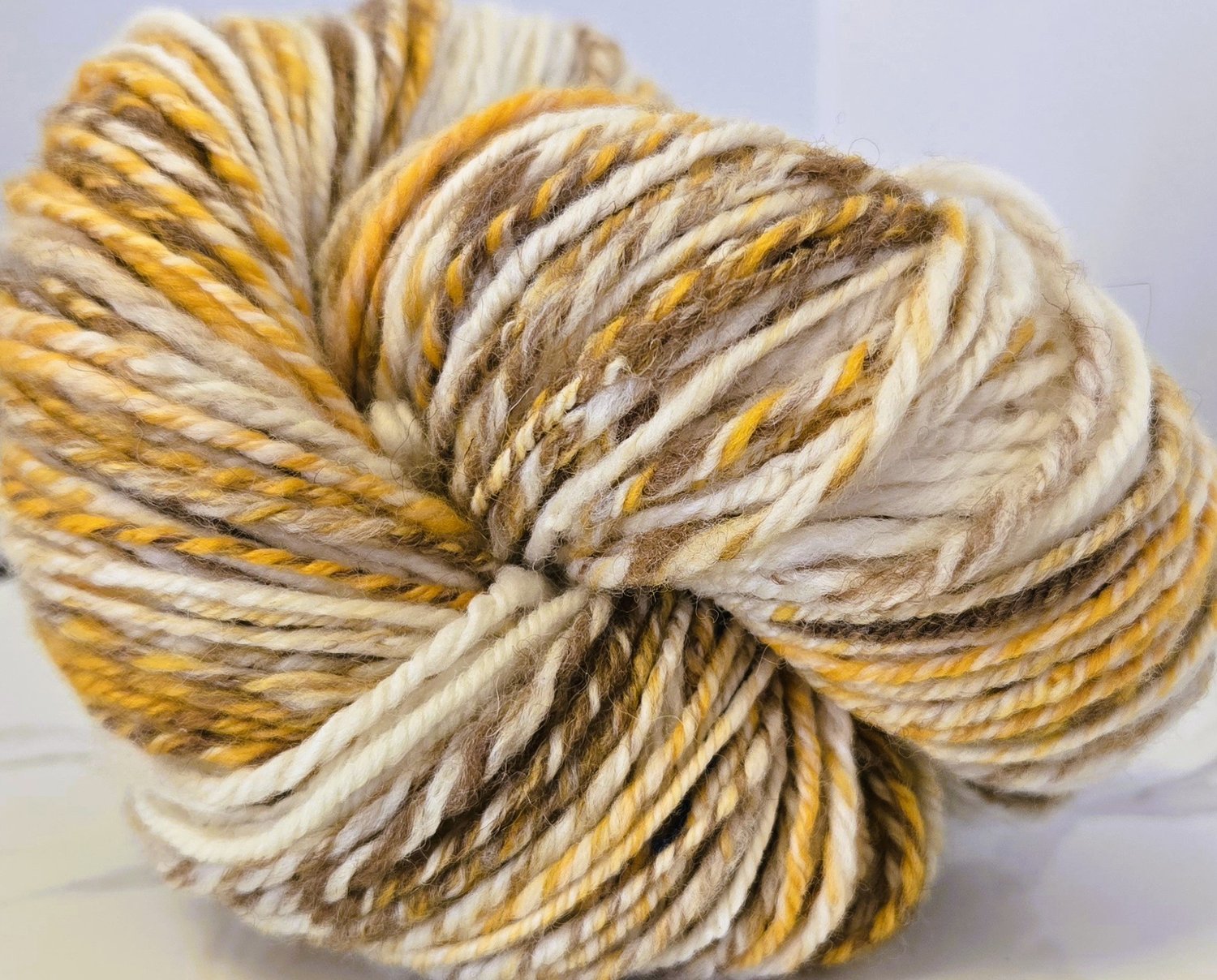 variegated white, gold, brown handspun yarn