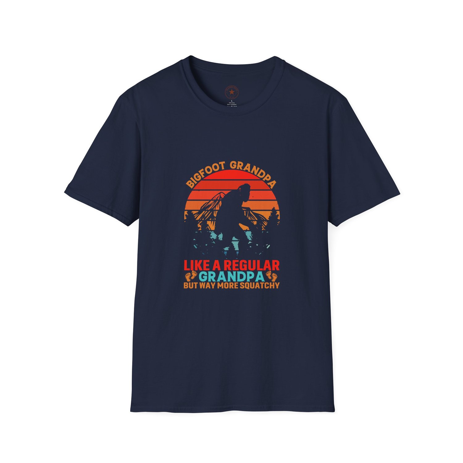 A classic Navy Blue soft-style t-shirt with a Sasquatch silhouette walking through a forest in front of an orange and teal retro sunset.