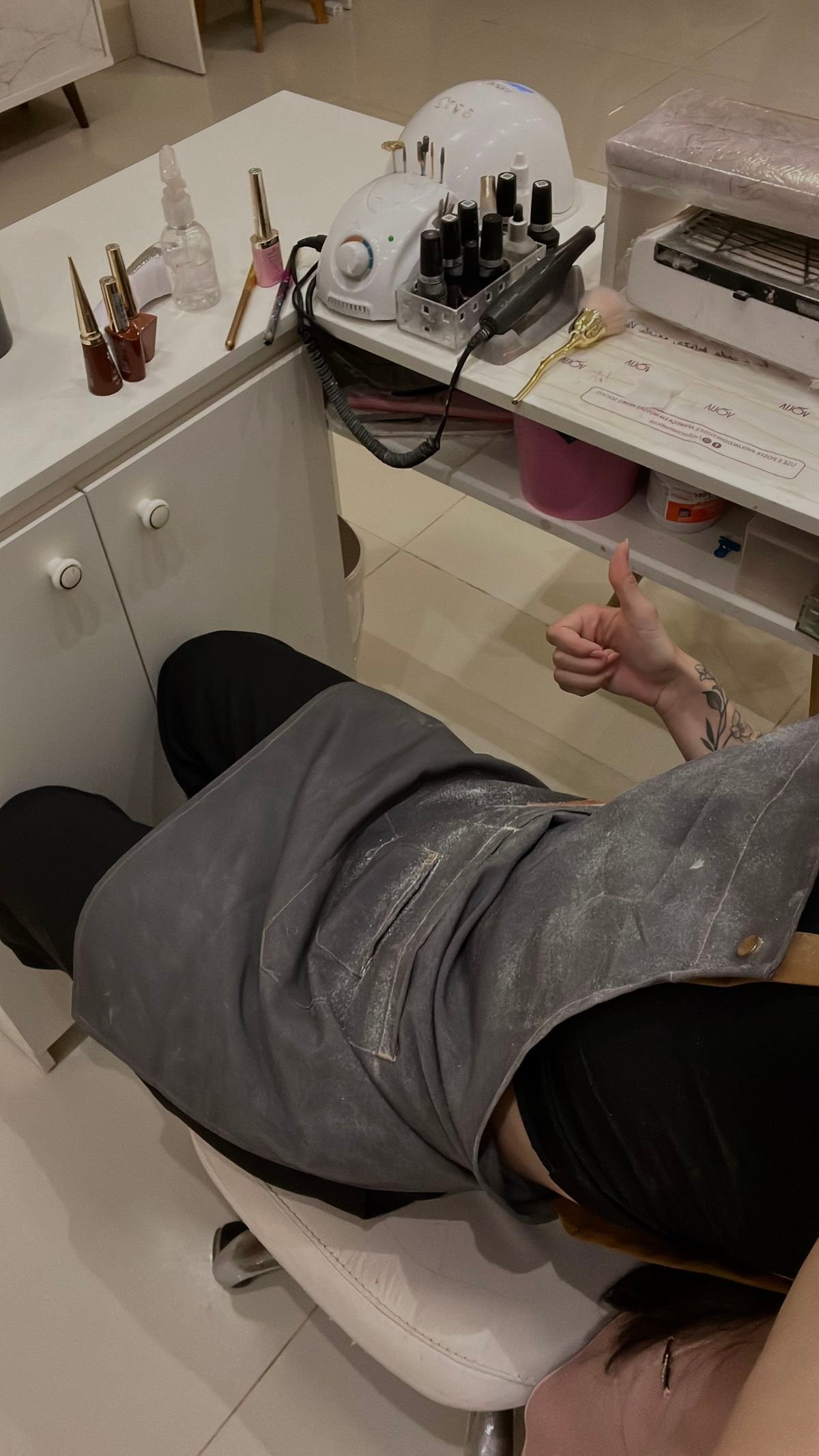 Nail technician engaging with a client during a consultation in a vibrant nail salon.