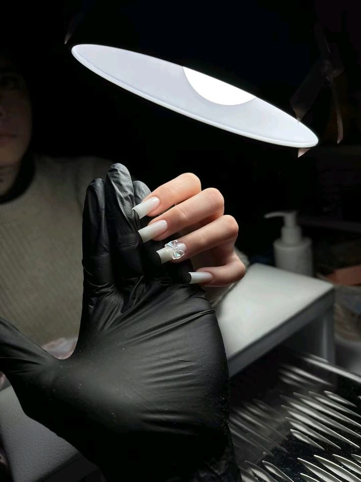 Nail technician engaging with a client during a consultation in a vibrant nail salon.
