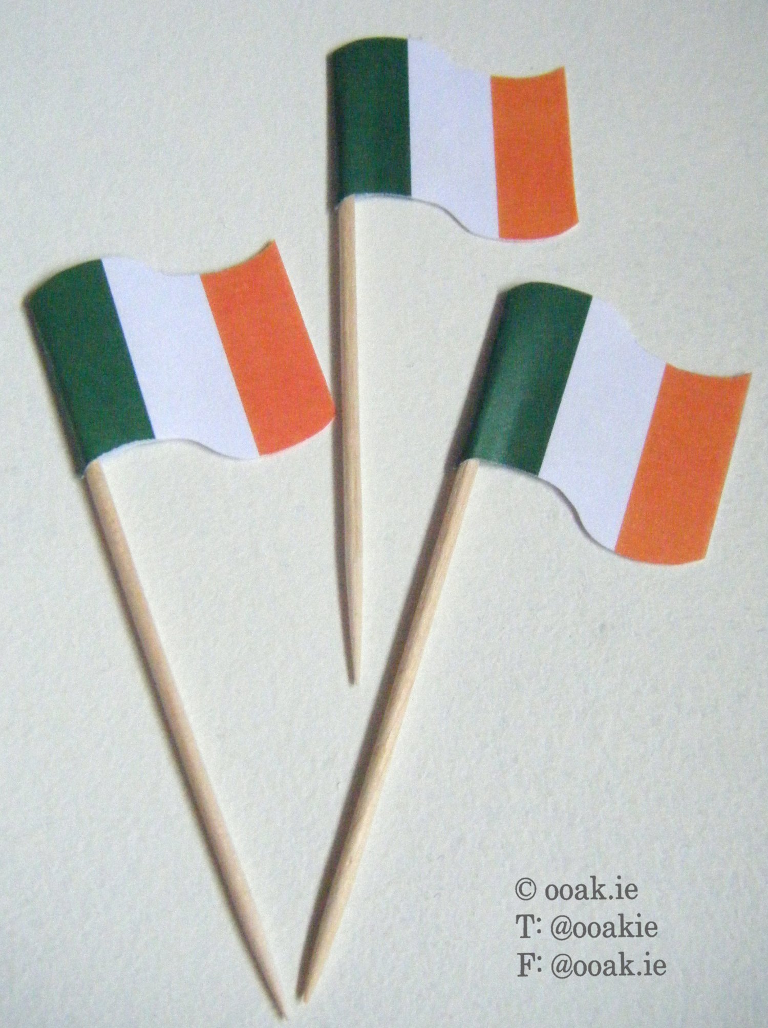 Sheet of printable mini Irish Tricolour flags in green, white, and orange for DIY St. Patricks Day cupcake toppers and cocktail sausages..