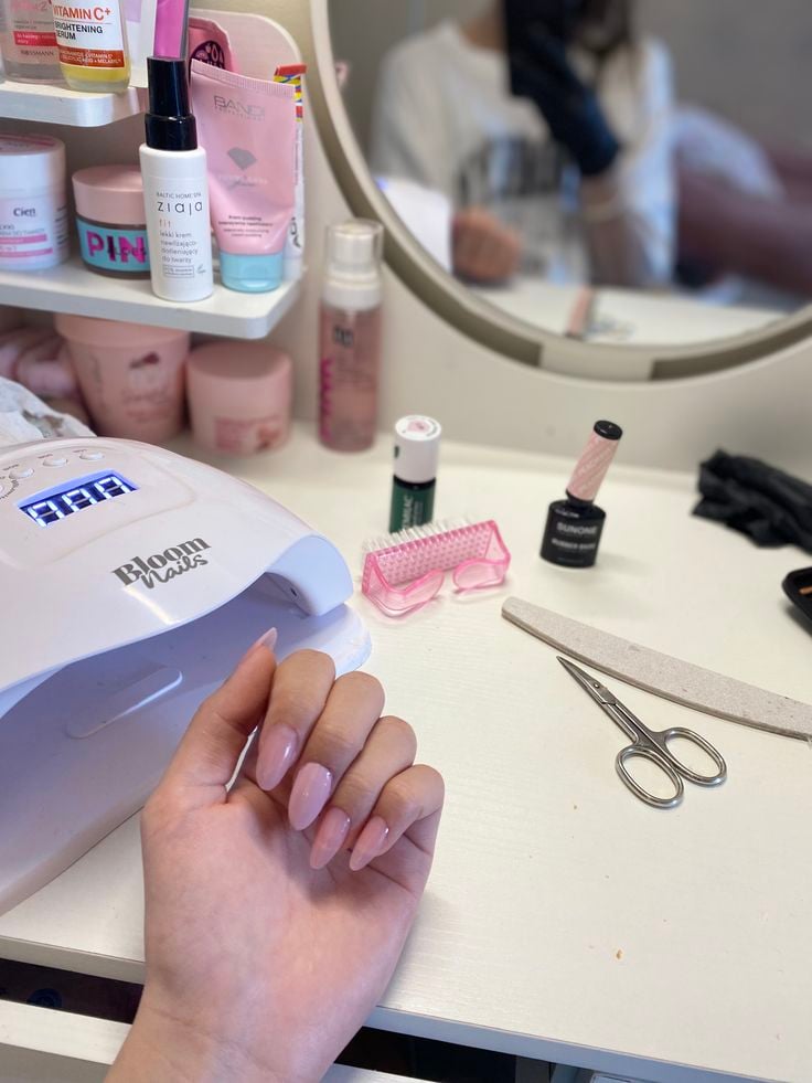 Nail technician professionally handling a client concern in a bright, welcoming nail salon.