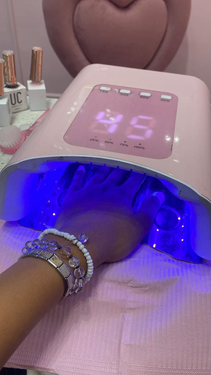 Nail technician conducting a detailed client consultation in a bright modern salon.
