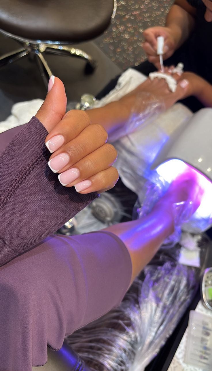 Seasonal nail trends displayed on manicure samples in a bright modern nail studio.