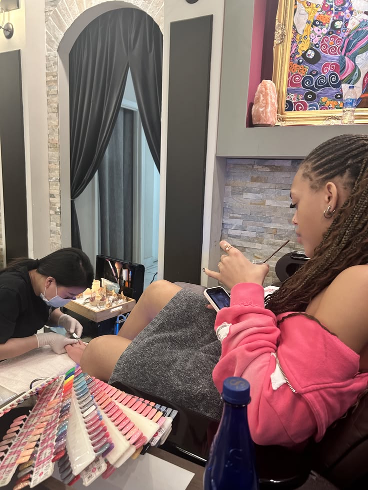 Nail technician handling a client concern professionally in a modern salon.