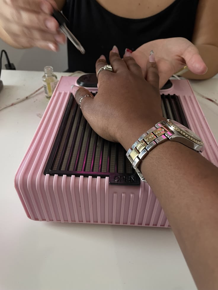 Nail technician suggesting add-ons to a client in a modern nail salon.