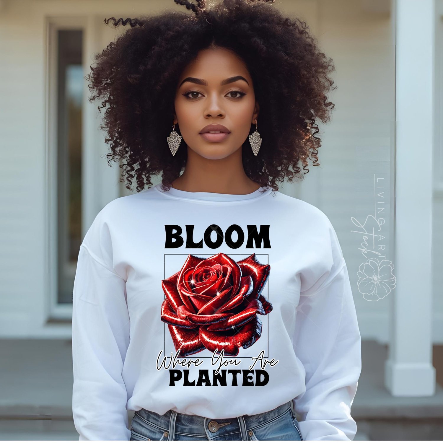 A vibrant t-shirt graphic design featuring a hyper-realistic, glossy red rose with a metallic sheen, set within a black wireframe square. Bold, chunky text above reads "BLOOM", and text below in script and bold fonts reads "Where You Are planted", all on 