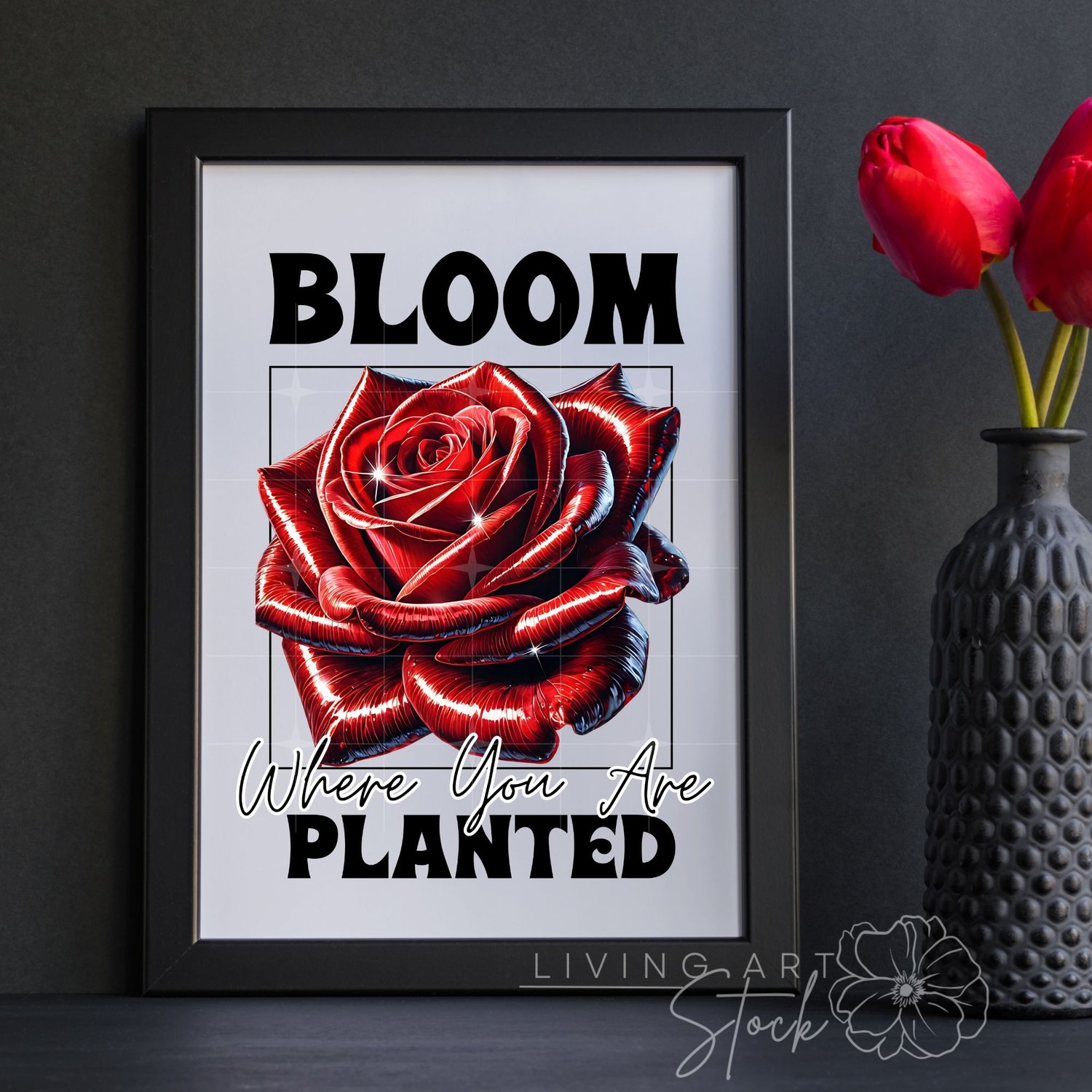 A vibrant t-shirt graphic design featuring a hyper-realistic, glossy red rose with a metallic sheen, set within a black wireframe square. Bold, chunky text above reads "BLOOM", and text below in script and bold fonts reads "Where You Are planted", all on 