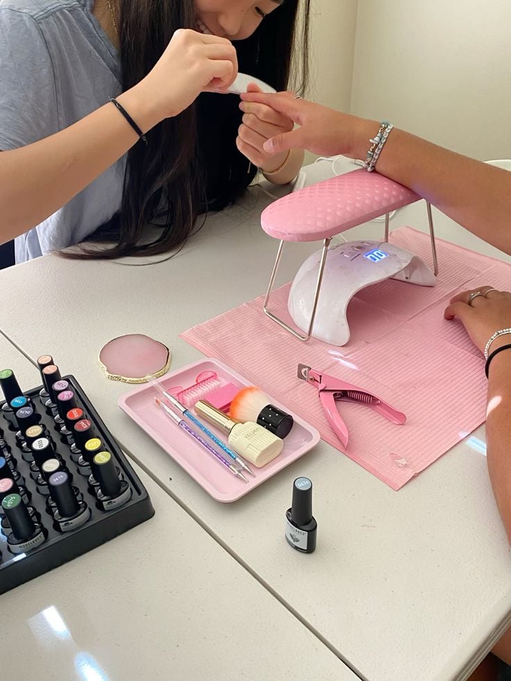 Nail technician exploring current trends to offer innovative services in a professional salon.