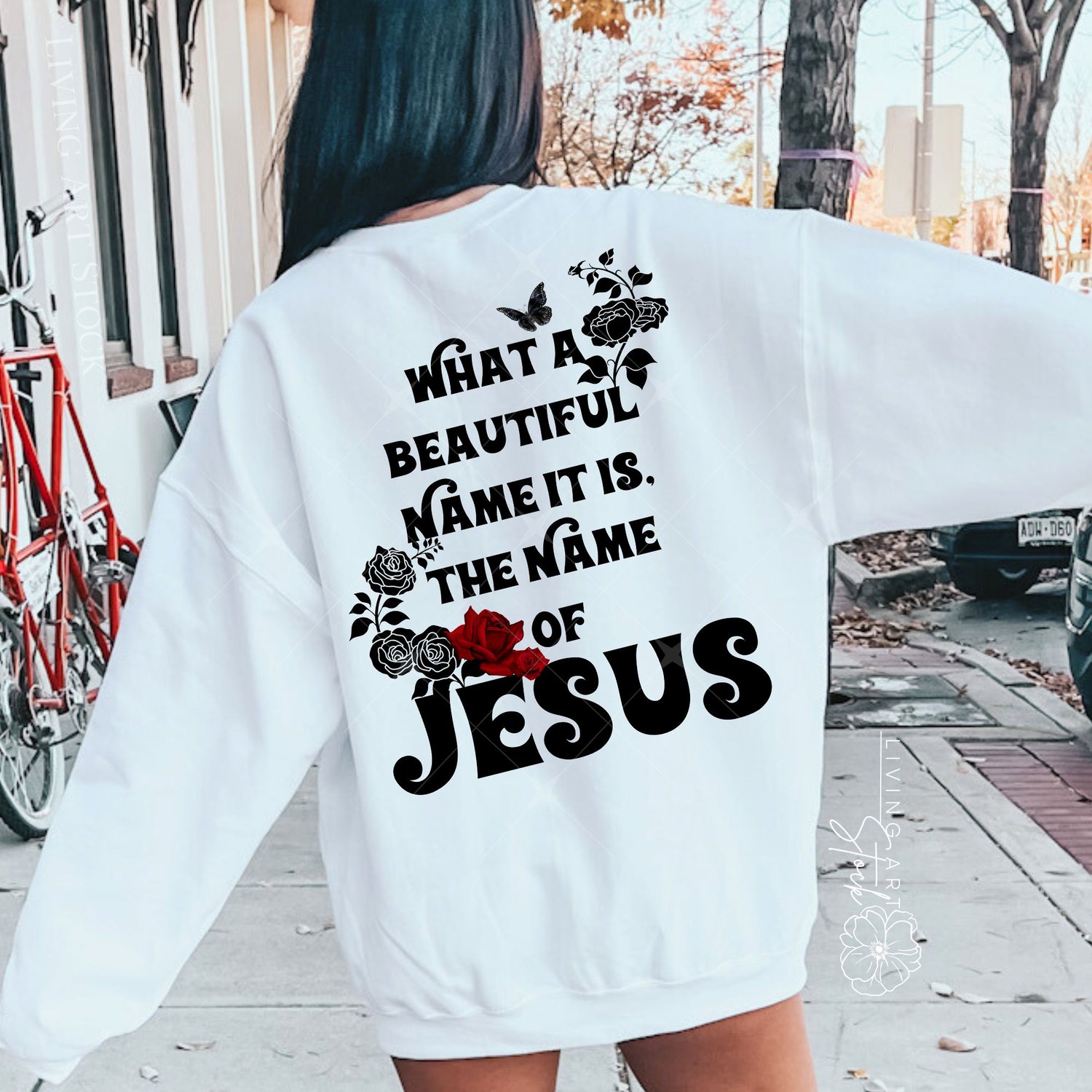 Black stylized text quote "What a Beautiful Name It Is, The Name of Jesus" on a white background, featuring red and black rose illustrations and a black butterfly.