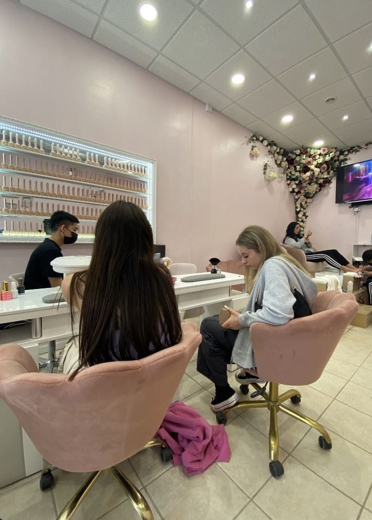 Nail technician managing salon pricing strategy to balance profitability and client satisfaction.