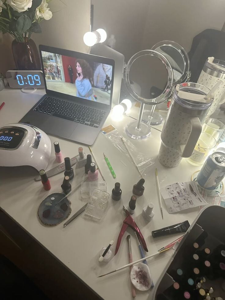 Nail technician managing studio schedule efficiently using digital tools for better client service.