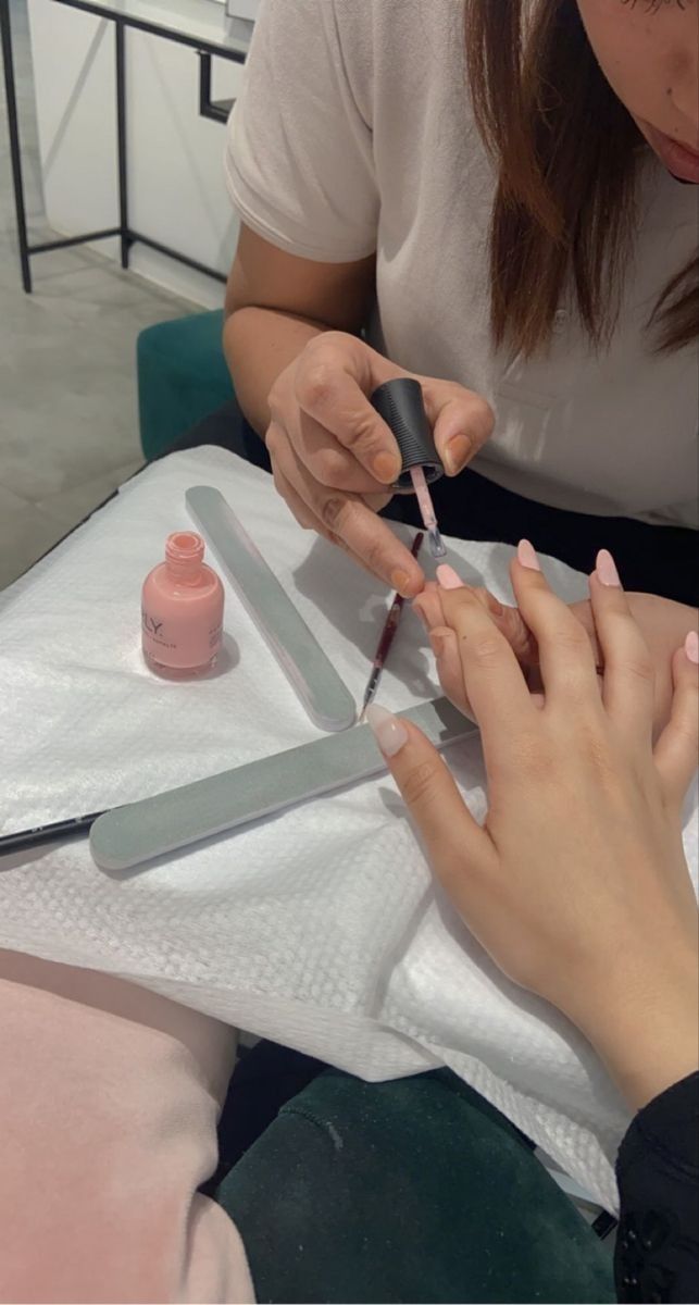 Nail technician creating seasonal nail art to attract clients and showcase trending designs.