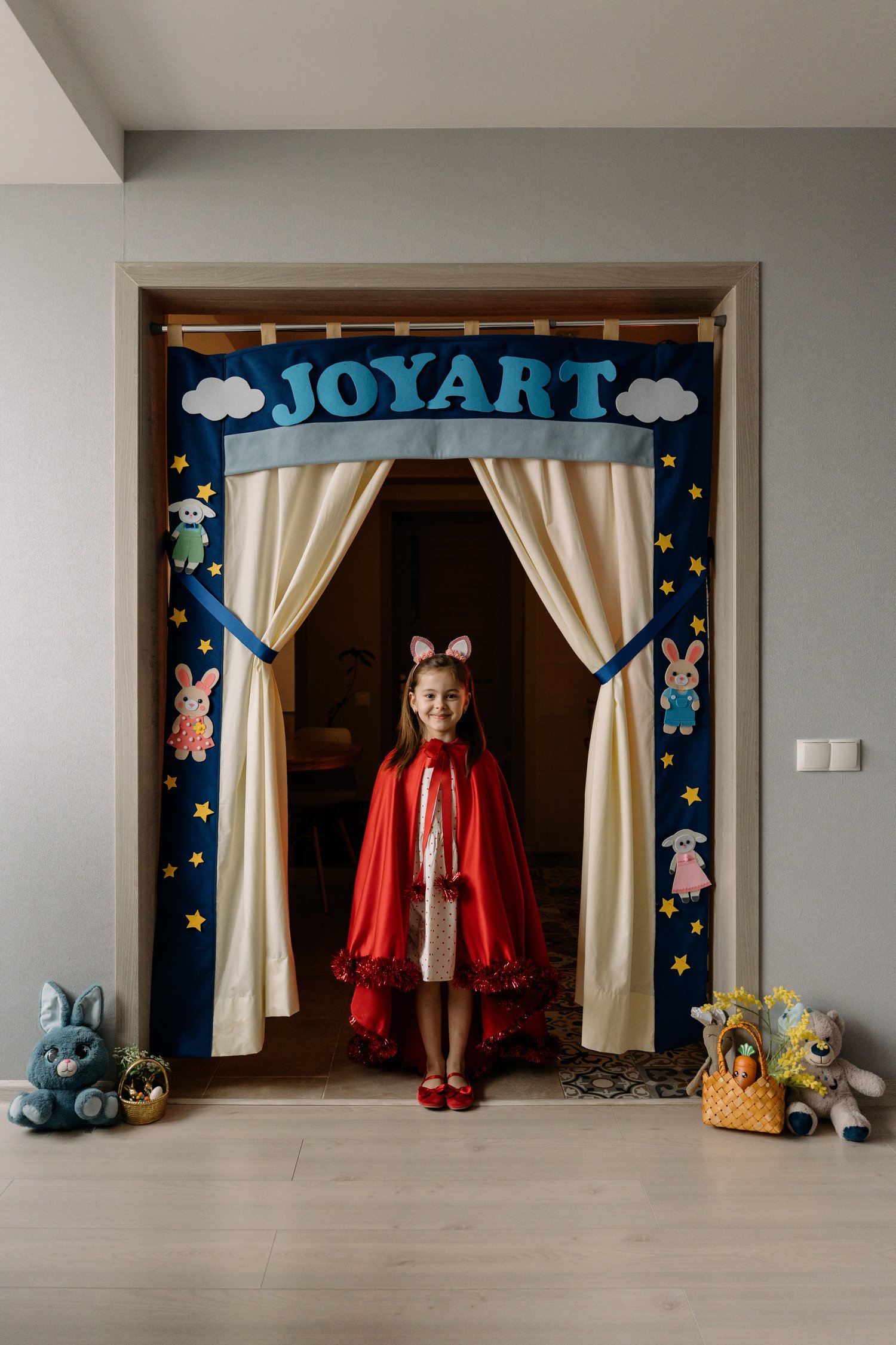 Child performing in JoyArt Doorway Theatre – handmade felt puppet theatre sewing pattern – kids imaginative play