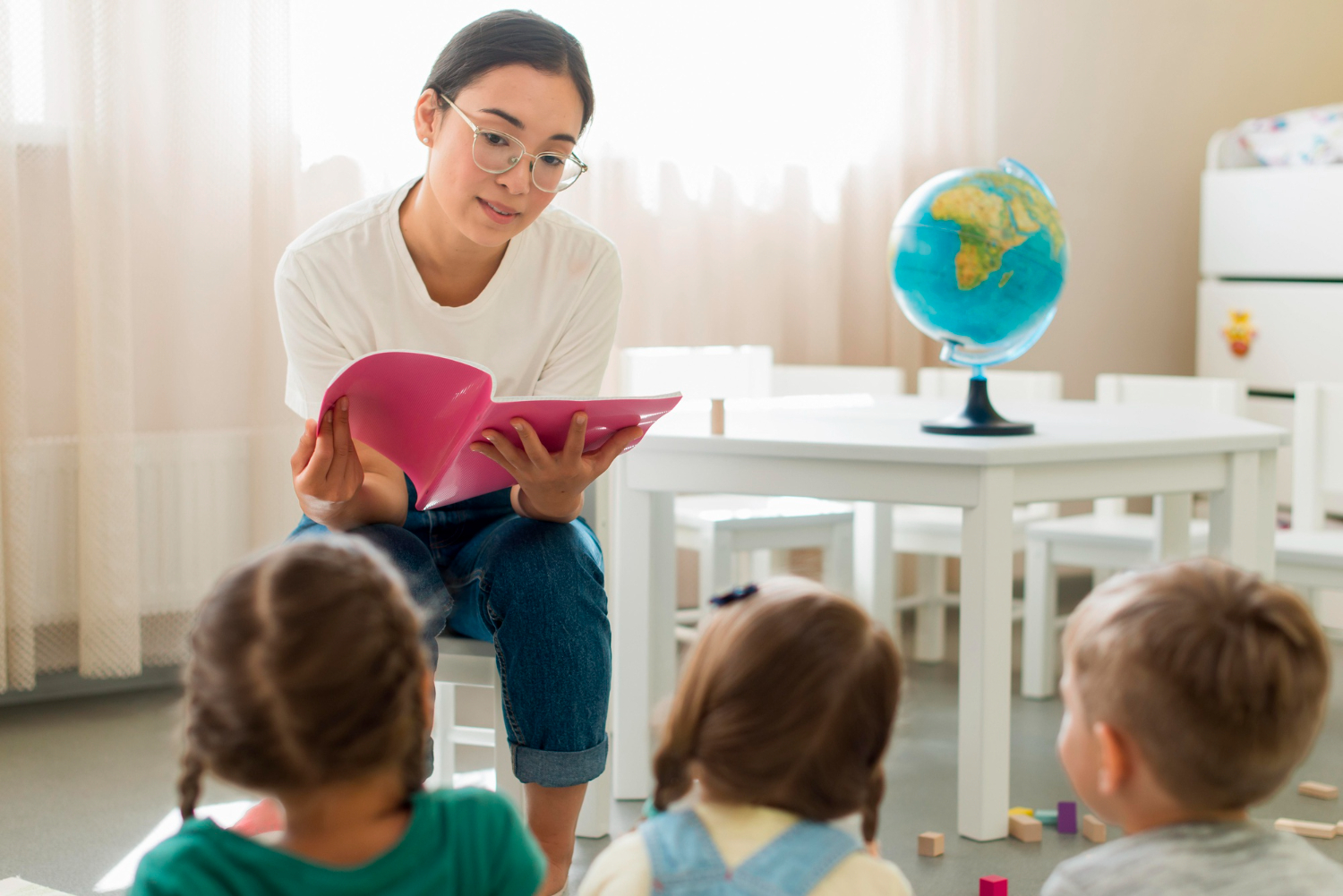 teacher reading something for her kindergarten students