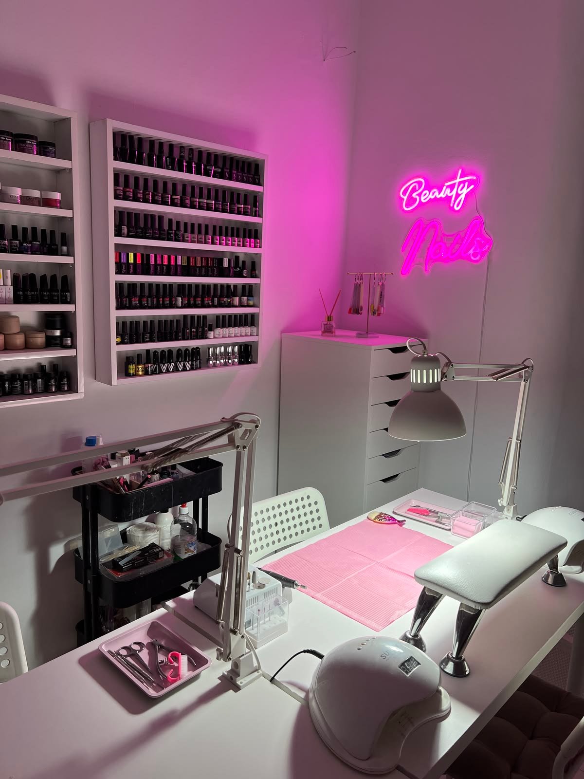 Nail technician learning new techniques and trends to improve skills and client satisfaction.