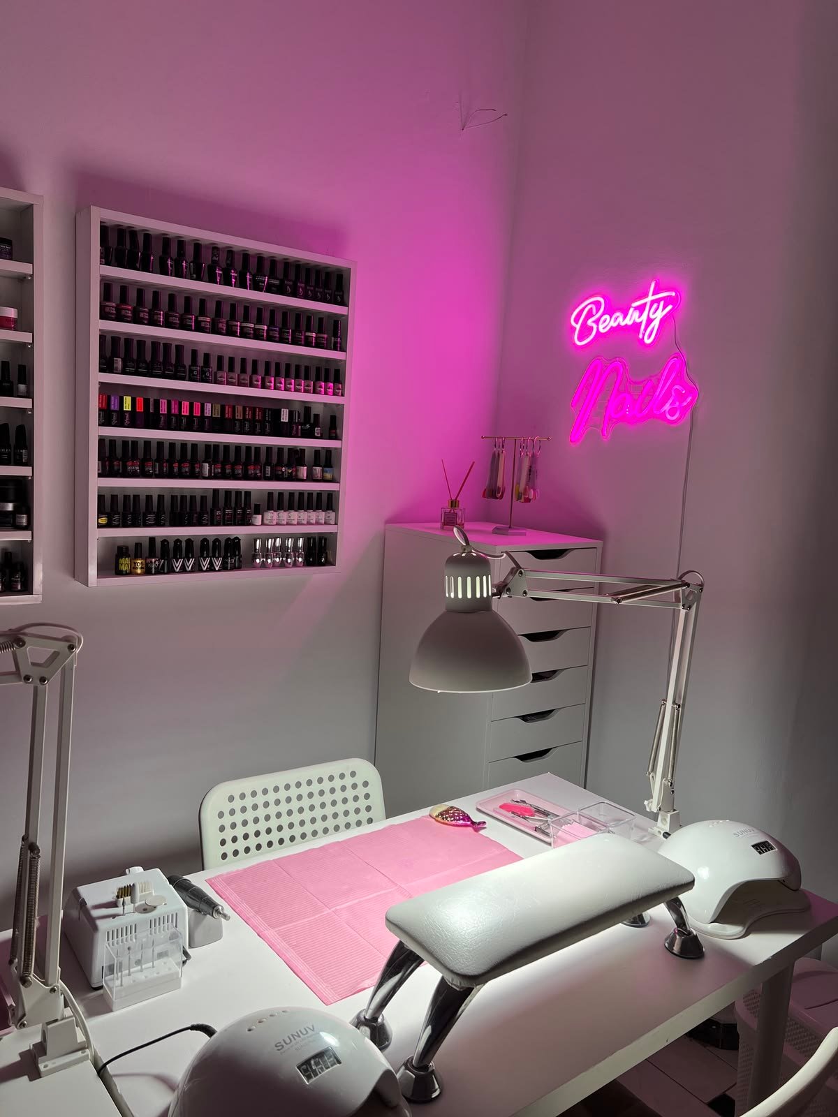 Nail technician learning new techniques and trends to improve skills and client satisfaction.