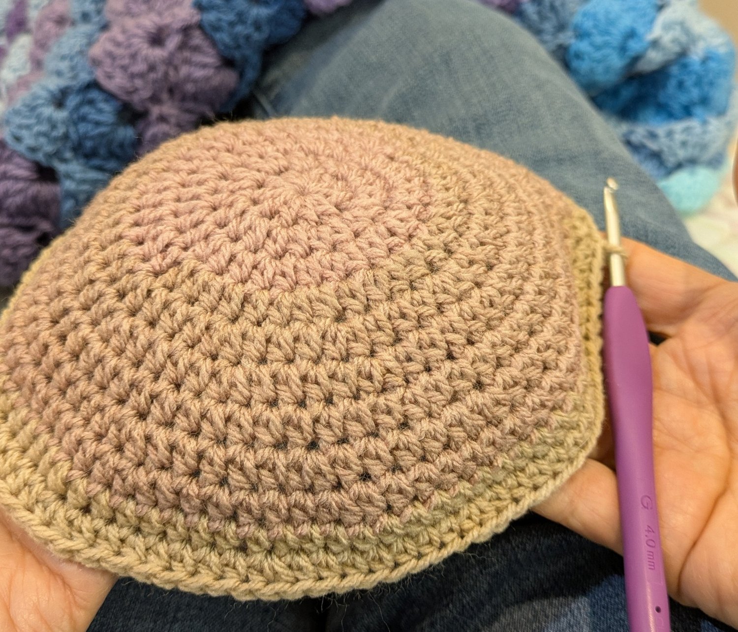 Crochet hat crown in progress showing top-down construction with increasing rounds and smooth stitch pattern using a 4.0 mm hook