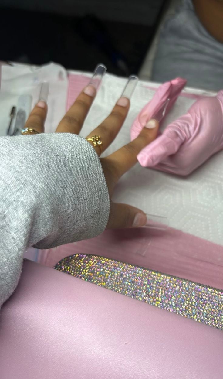 Nail technician setting strategic pricing for services to increase profit and maintain client loyalty.