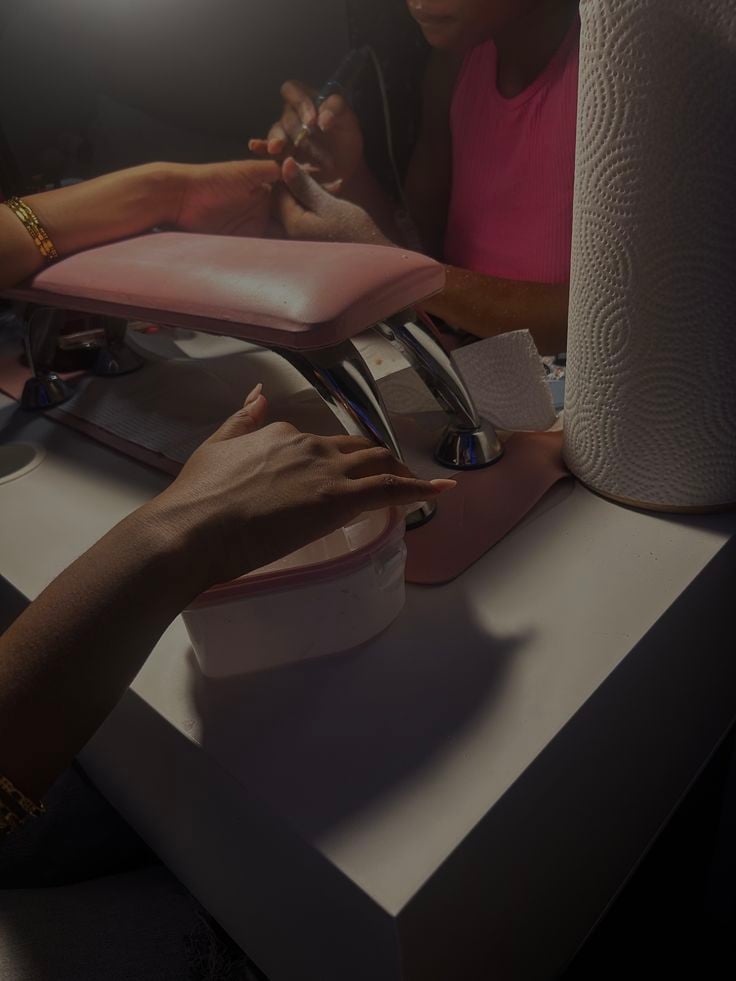 Nail technician setting strategic pricing for services to increase profit and maintain client loyalty.
