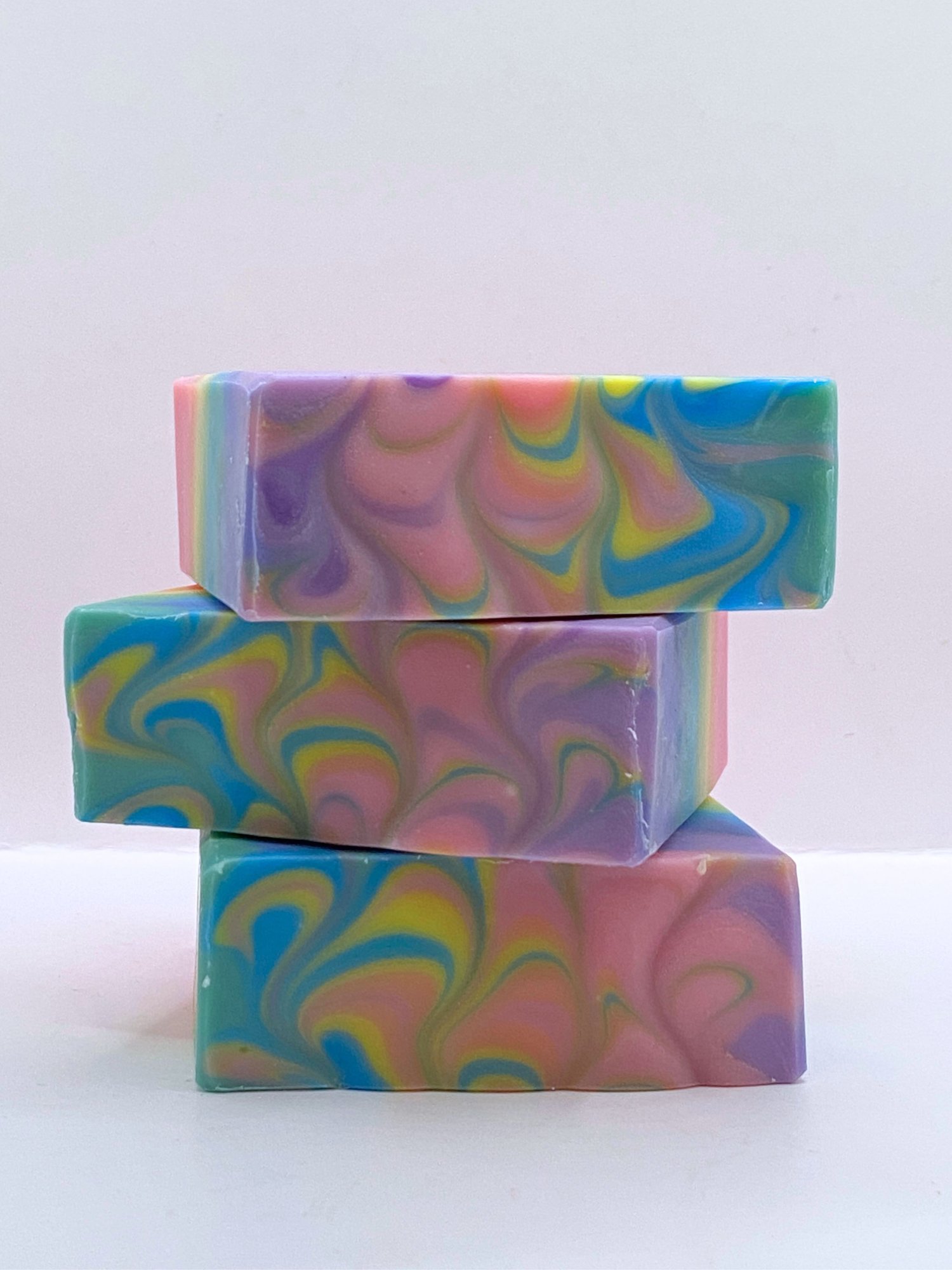 stack of multicolored rainbow handmade soaps