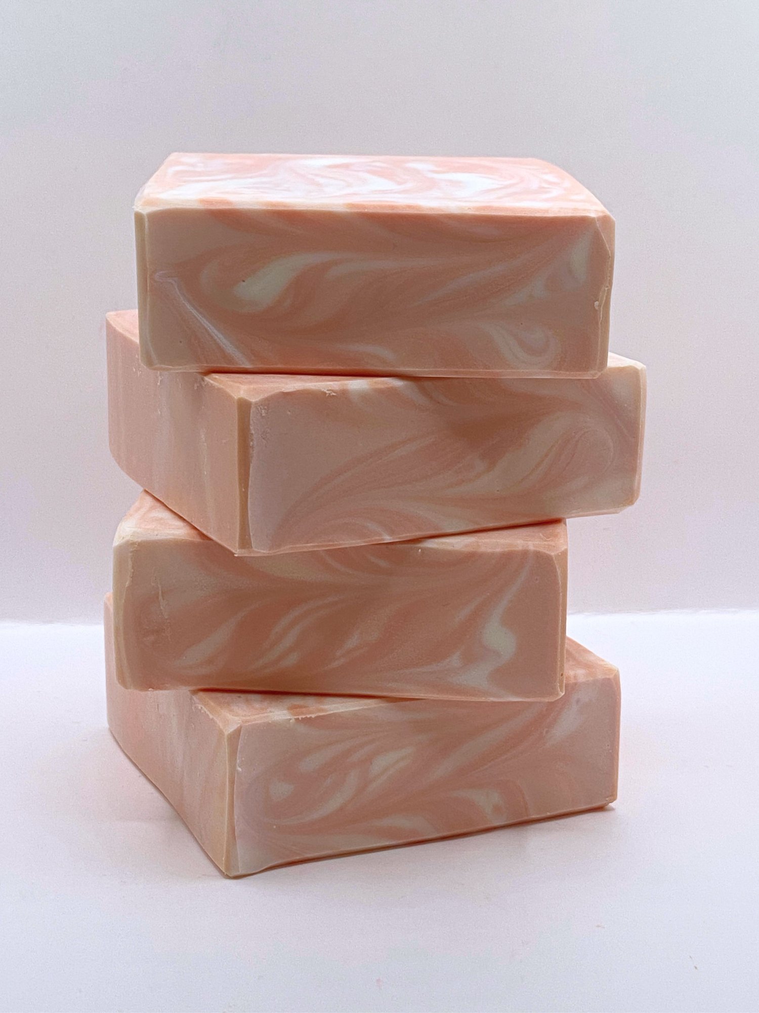 Stack of peachy-pink handmade soap bars