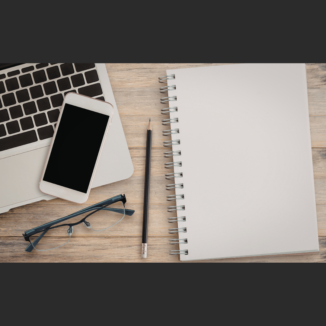 Business tools including phone, laptop and notepad for business growth coaching and SEO strategy - Rachel Borscz