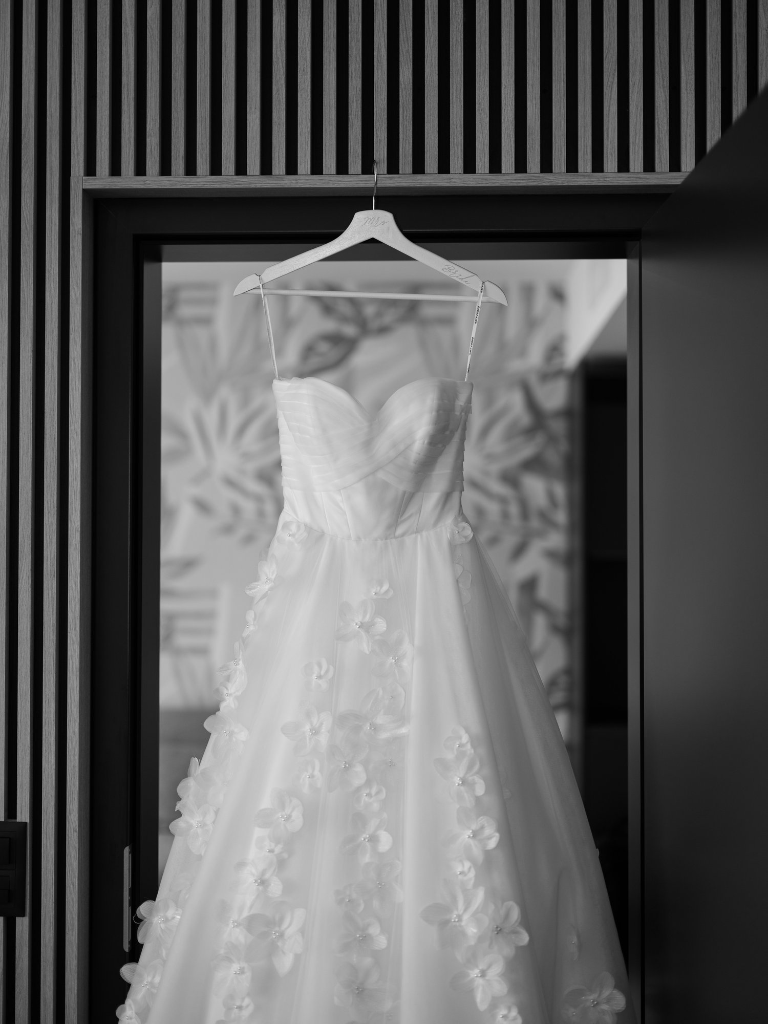 wedding dress hanging on a door frame