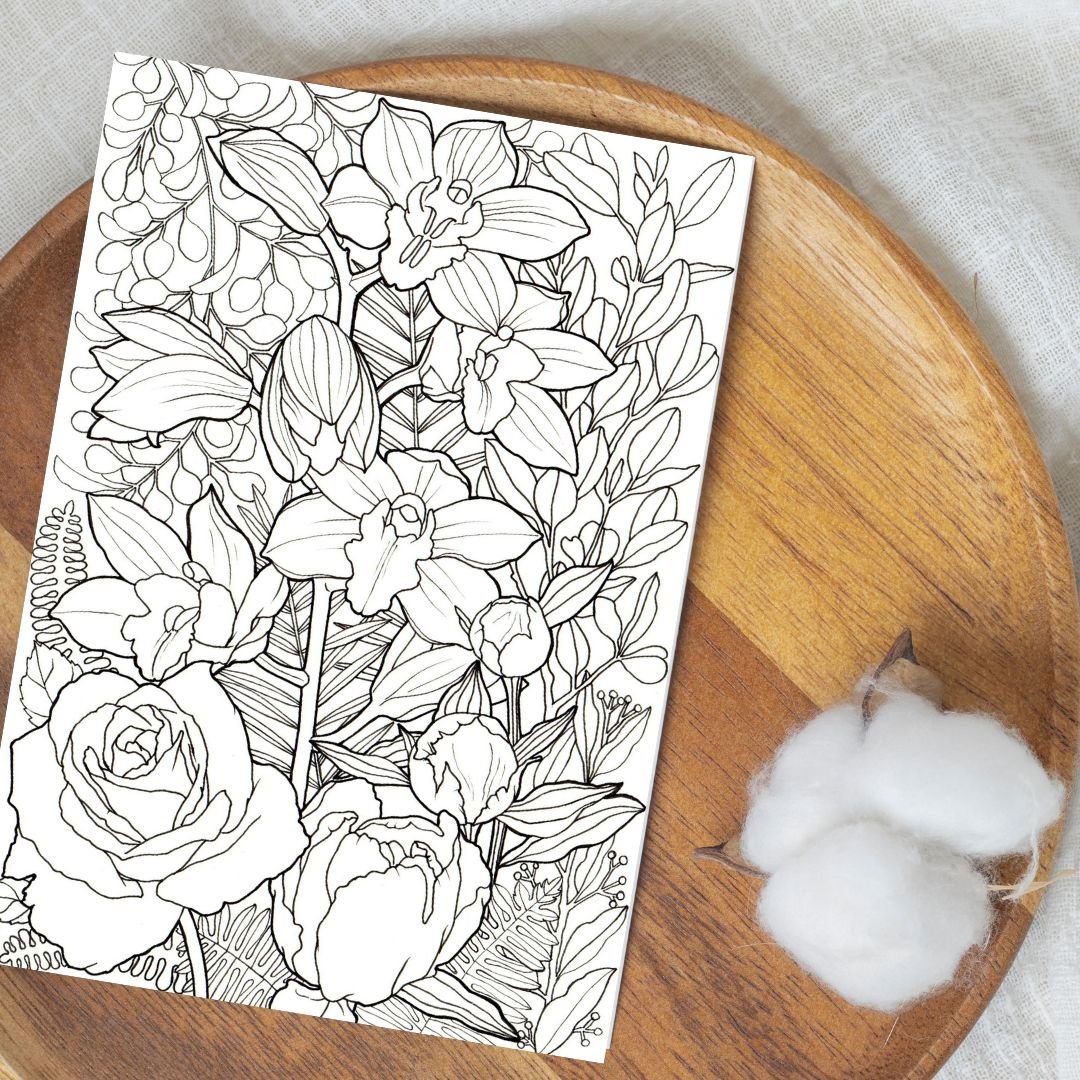 floral colouring page placed on a wooden round tray platter with natural cotton balls