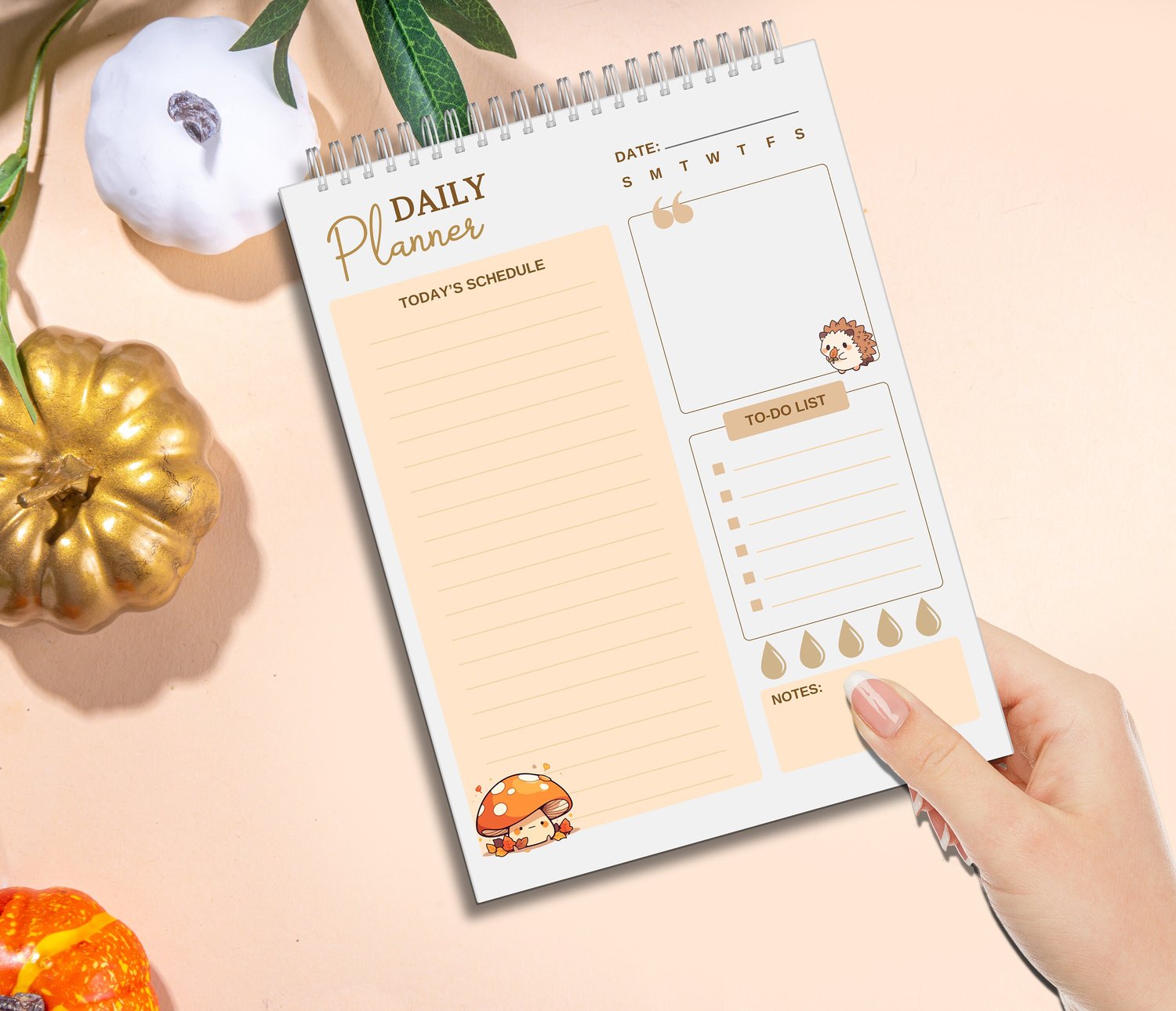 Spiral‑bound autumn daily planner featuring pumpkins, hedgehog, and mushroom illustrations, with sections for schedule, to‑do list, notes, and quote of the day.