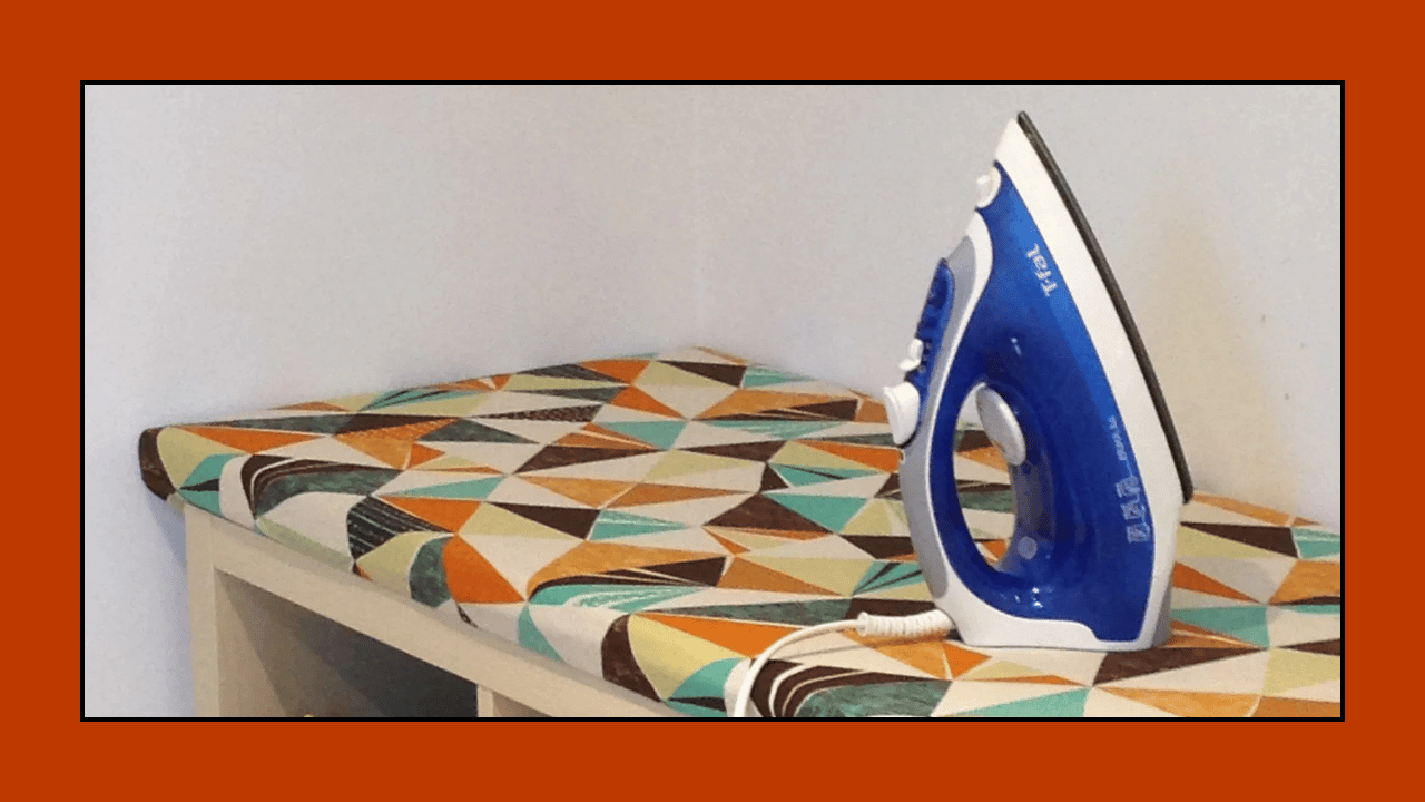 Iron sitting on a custom ironing board