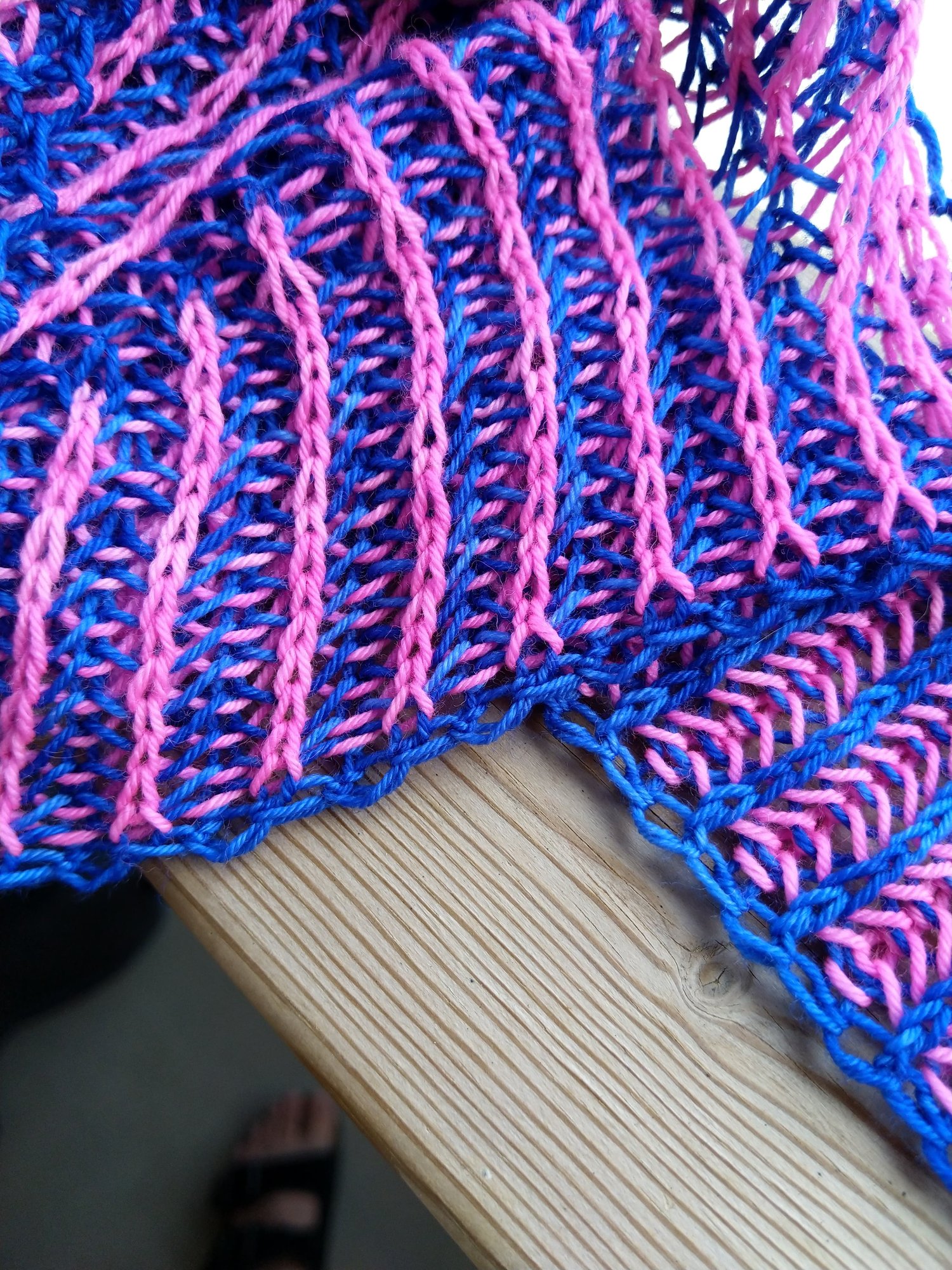 A close up of a bright pink and bright blue Waterfall Shawl