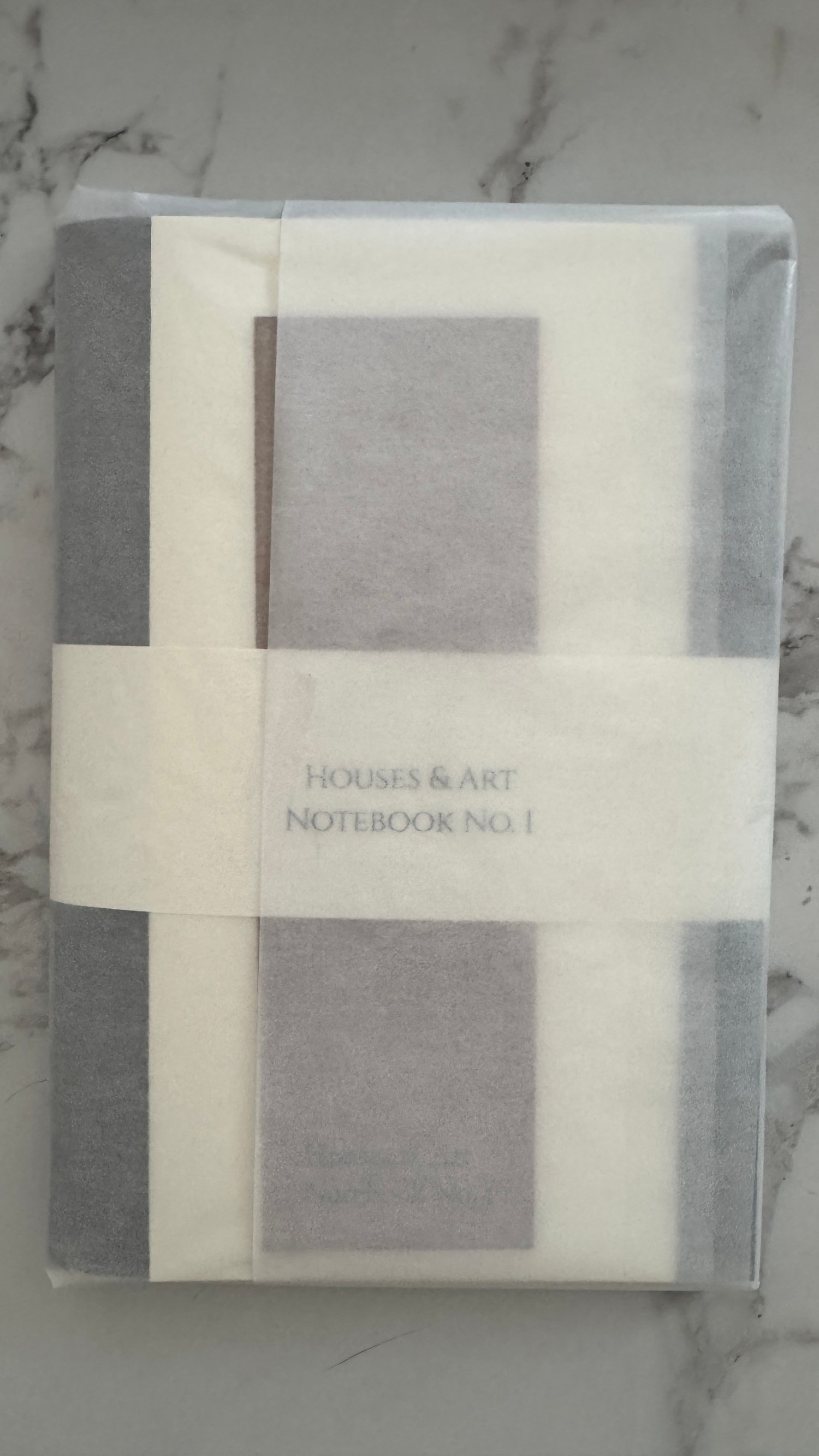 Notebook wrapped in glassine packaging