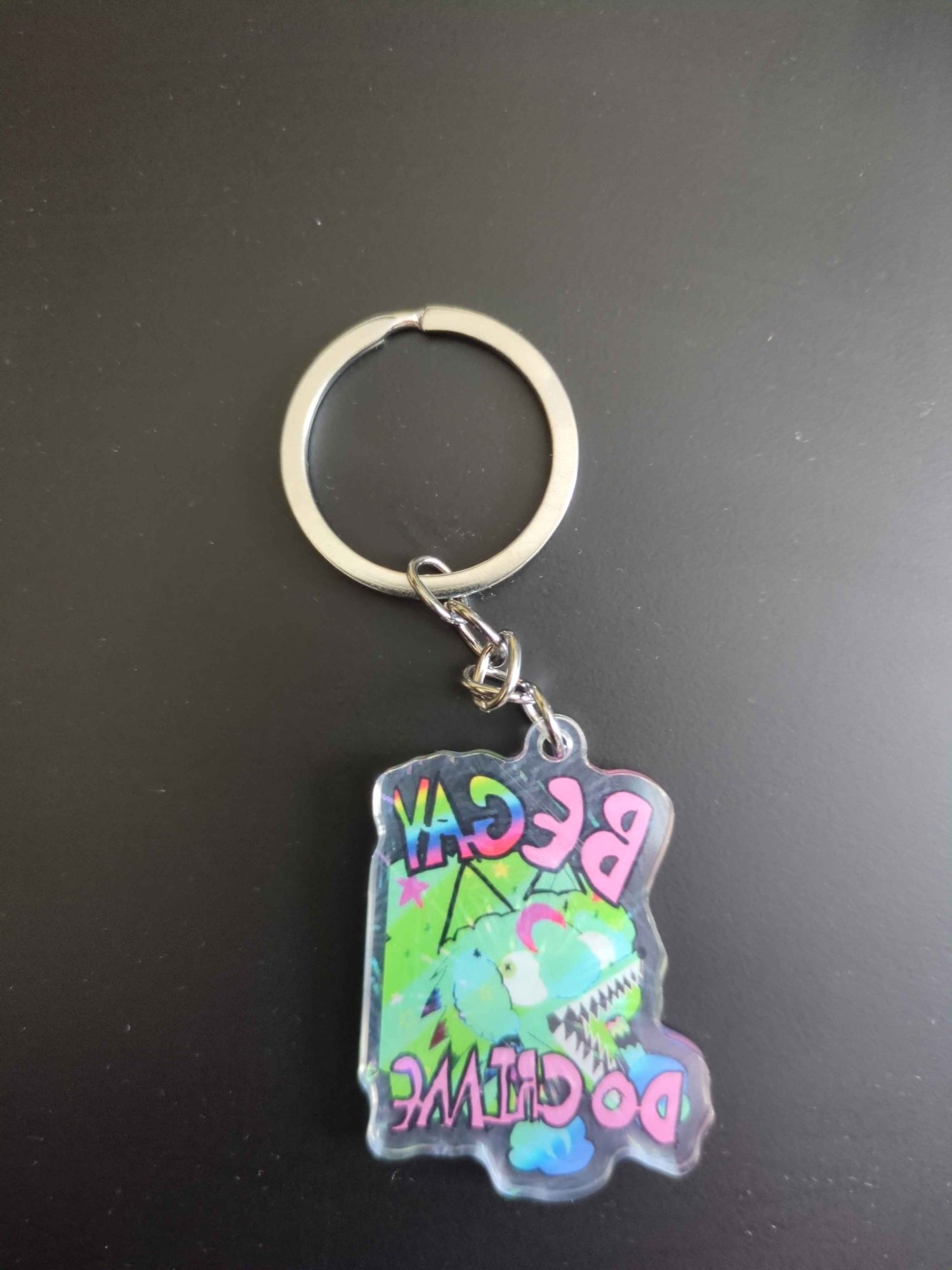 Green Sparkle COyote girl head in green sparkles covered in stars and moons blue green gradient with pink text that reads "Be Gay Do Grime" Gay text is rainbor. Wide mouth, braids and eyes looking the wrong directions. back mirrored