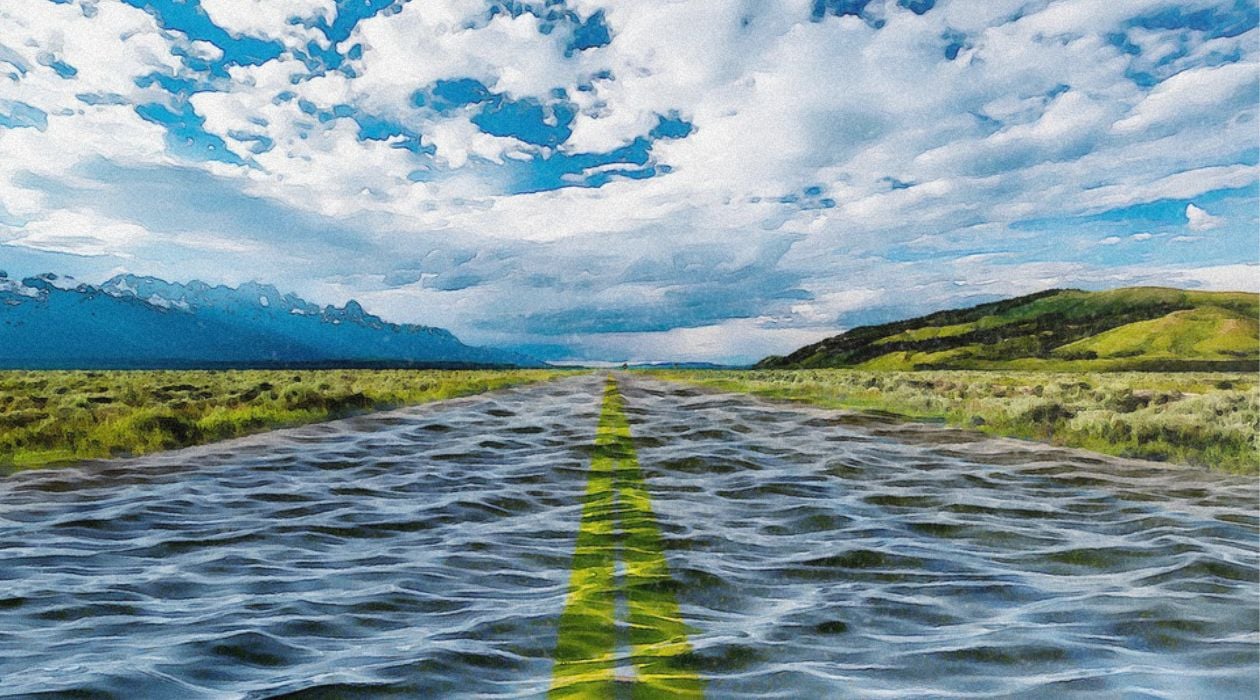 A digital illustration depicts a watery road, a field at each side, and a sky with clouds.