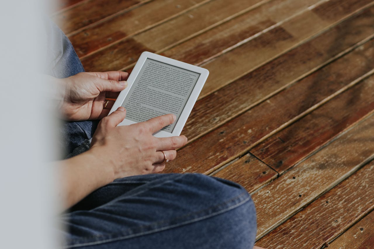 a person holding an eBook reader and reading an eBook to learn a new skill